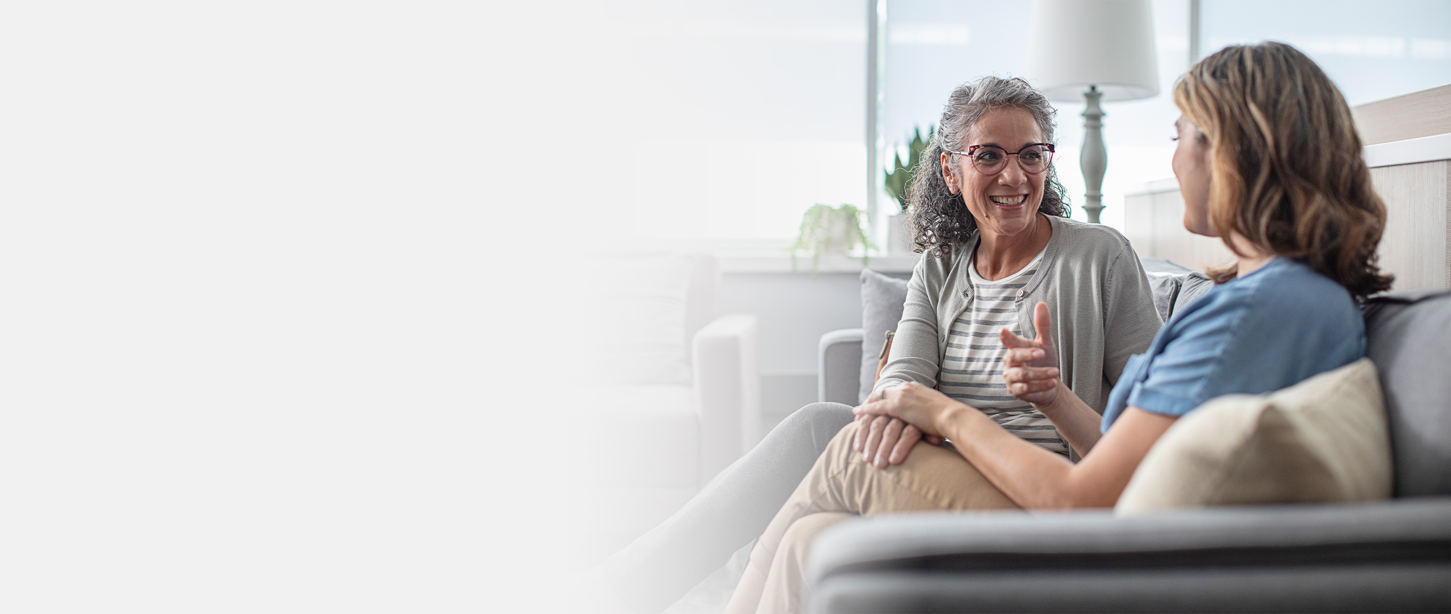 Two women chatting on a couch