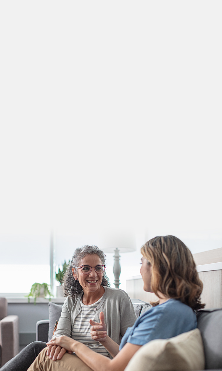 Two women chatting on a couch